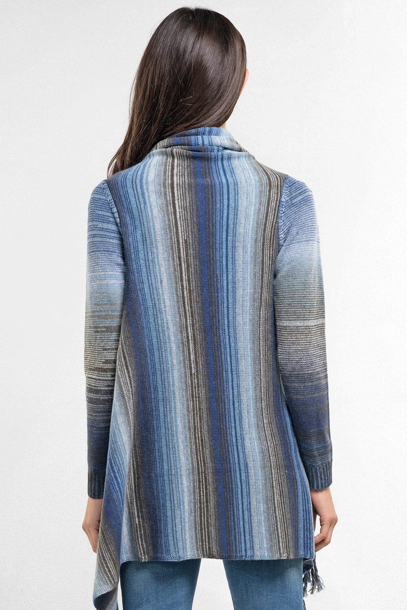 [Color: Heather Ocean/Grey] An image of a model wearing a striped shawl cardigan with a fringe trim and wrap button closure. 