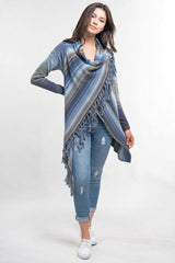 [Color: Heather Ocean/Grey] An image of a model wearing a striped shawl cardigan with a fringe trim and wrap button closure. 