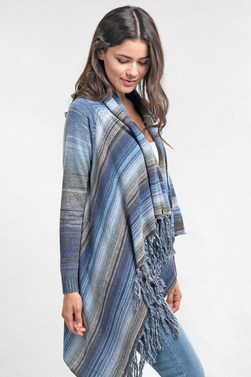 [Color: Heather Ocean/Grey] An image of a model wearing a striped shawl cardigan with a fringe trim and wrap button closure. 