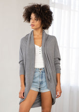 [Color: Heather Charcoal] A brunette model wearing a slouchy cardigan with a cocoon fit, shawl collar drape, and long dolman sleeves. This relaxed style is the perfect casual staple for any fall wardrobe. 