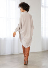 [Color: Heather Stone] A brunette model wearing a slouchy cardigan with a cocoon fit, shawl collar drape, and long dolman sleeves. This relaxed style is the perfect casual staple for any fall wardrobe. 