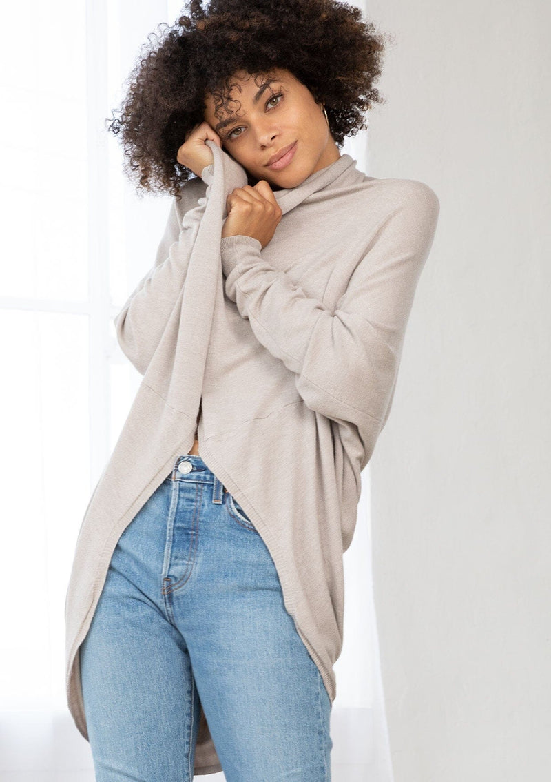 [Color: Heather Stone] A brunette model wearing a slouchy cardigan with a cocoon fit, shawl collar drape, and long dolman sleeves. This relaxed style is the perfect casual staple for any fall wardrobe. 