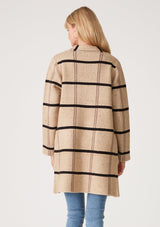 [Color: Khaki/Black] A full body front facing image of a brunette model wearing a soft mid length cardigan in a khaki brown and black windowpane plaid. With long sleeves, deep side pockets, and an open front.