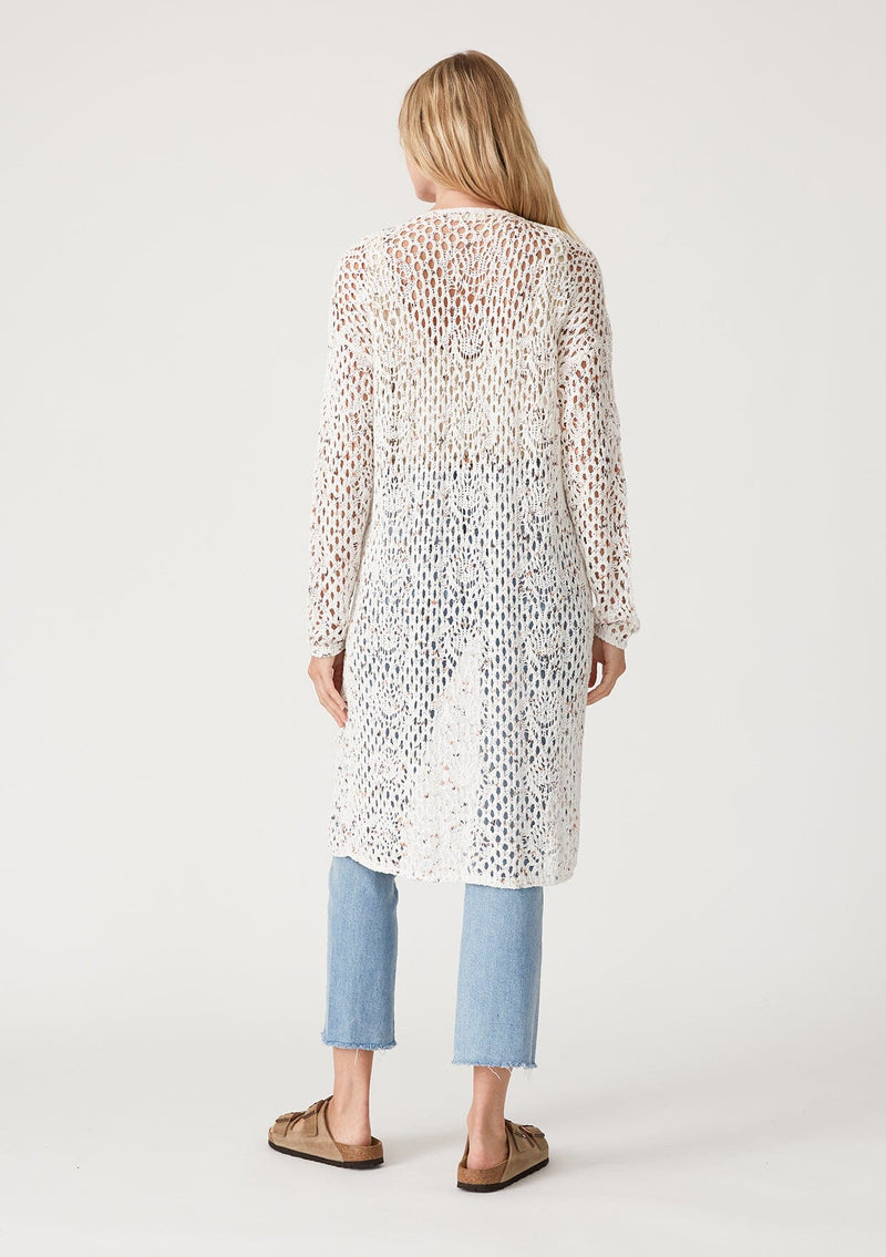 [Color: Ivory/Coral] A back facing image of a blonde model wearing an ivory speckled knit crochet cardigan. A lightweight sweater with long sleeves, a mid length, and an open front. 