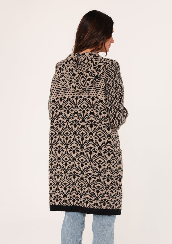 [Color: Taupe/Black] A back facing image of a brunette model wearing a soft boho cardigan in a brown and black abstract pattern. With a hoodie, an open front, a mid length hemline, and side pockets. 