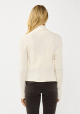[Color: Natural] A photo of a Lovestitch model wearing a chic ivory waffle knit wrap front sweater with long sleeves, a v neckline, and a button closure at the back. The long ties can be styled in multiple ways.
