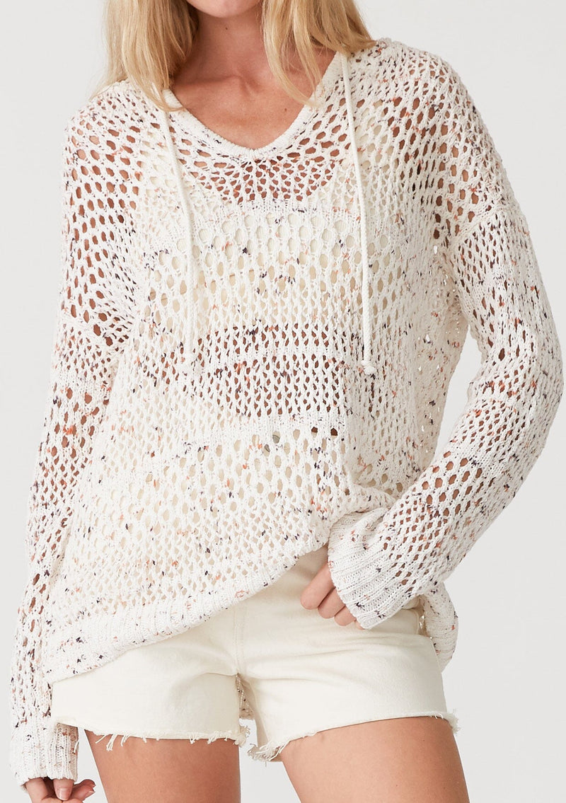 [Color: Ivory/Coral] A close up front facing image of a blonde model wearing a lightweight crochet hoodie in an ivory speckled knit. With long sleeves, a v neckline, a drawstring hoodie, and a dropped shoulder. 