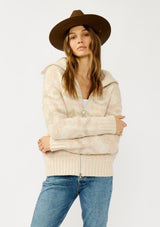 [Color: Natural/Dusty Pink] A front facing image of a blonde model wearing a beige southwestern boho sweater jacket with a zipper front and ribbed trims. A fall cozy sweater. 