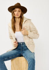 [Color: Natural/Dusty Pink] A front facing image of a blonde model wearing a beige southwestern boho sweater jacket with a zipper front and ribbed trims. A fall cozy sweater. 
