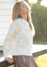 [Color: Ivory/Light Blush] A side facing image of a blonde model wearing cozy knit sweater with a floral jacquard pattern. Featuring a classic crew neckline, cozy long sleeves, and ribbed trims. A fall trending sweater for cold weather styling. 