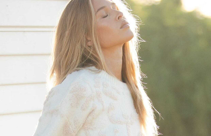 Woman wearing a white fur coat with a blurred background