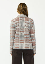 [Color: Charcoal] A back facing image of a brunette model wearing a southwestern fuzzy jacket with a notched collar, button front, and patch pockets. 
