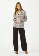 [Color: Charcoal] A front facing image of a brunette model wearing a southwestern fuzzy jacket with a notched collar, button front, and patch pockets. Paired with dark brown denim and boots. 