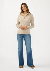 [Color: Heather Cement] A front facing image of a brunette model wearing a brown pointelle knit sweater with a half zip up. 
