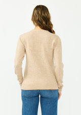 [Color: Heather Sand] A back facing image of a brunette model wearing a light brown crew neck sweater with sequins and embellishment. 