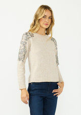 [Color: Oatmeal] A front facing image of a blonde model wearing a speckled beige pullover sweater with a crew neckline and sequins along the shoulder.