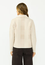 [Color: Natural/Taupe] A back facing image of a brunette model wearing a beige plaid sweater jacket with a fuzzy texture, collared neck, button front, and patch pockets. 