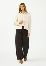 [Color: Natural/Taupe] A front facing image of a brunette model wearing a beige plaid sweater jacket with a fuzzy texture, collared neck, button front, and patch pockets. 