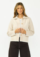 [Color: Natural/Taupe] A front facing image of a brunette model wearing a beige plaid sweater jacket with a fuzzy texture, collared neck, button front, and patch pockets. 