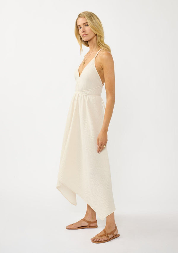 [Color: Cream] A sexy strappy cream halter dress in airy cotton gauze. With a plunging v neckline, handkerchief hemline, and long straps that can be tied in multiple ways.