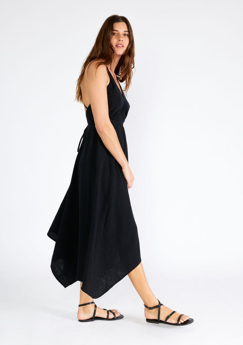 [Color: Black] A sexy strappy black halter dress in airy cotton gauze. With a plunging v neckline, handkerchief hemline, and long straps that can be tied in multiple ways.