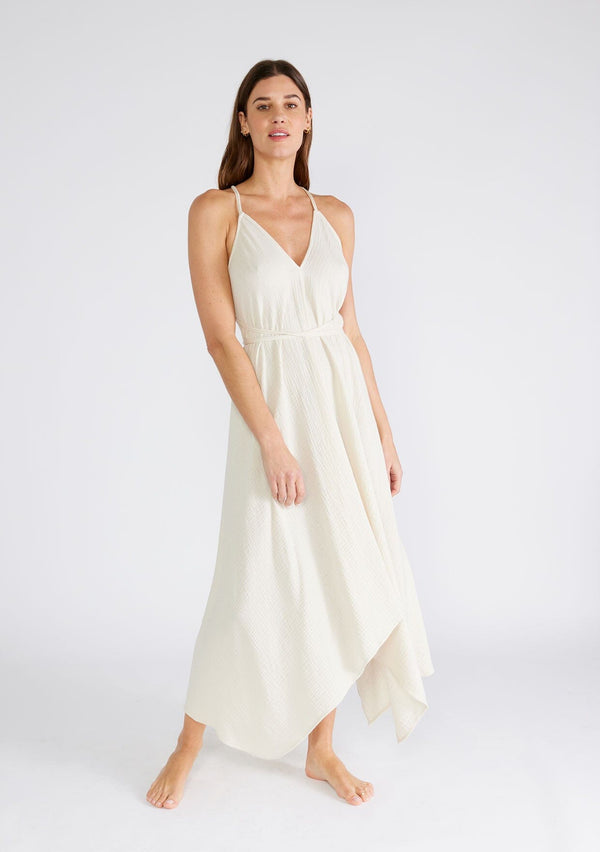 [Color: Cream] A sexy strappy cream halter dress in airy cotton gauze. With a plunging v neckline, handkerchief hemline, and long straps that can be tied in multiple ways.
