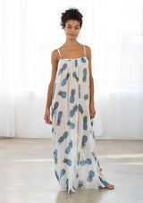 [Color: Blue/Ivory] A front facing image of a brunette model wearing a sheer blue and white pineapple print maxi dress with a scoop neckline and adjustable spaghetti straps. 