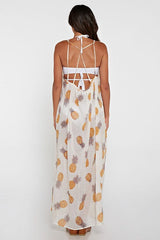 [Color: Gold/Ivory] A back facing image of a brunette model wearing a sheer yellow and white pineapple print maxi dress with a scoop neckline and adjustable spaghetti straps, and strappy back design.