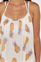 [Color: Gold/Ivory] A detail image of a brunette model wearing a sheer yellow and white pineapple print maxi dress with a scoop neckline and adjustable spaghetti straps, and strappy back design.