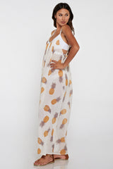 [Color: Gold/Ivory] A side facing image of a brunette model wearing a sheer yellow and white pineapple print maxi dress with a scoop neckline and adjustable spaghetti straps, and strappy back design.