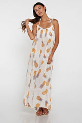 [Color: Gold/Ivory] A front facing image of a brunette model wearing a sheer yellow and white pineapple print maxi dress with a scoop neckline and adjustable spaghetti straps, and strappy back design.