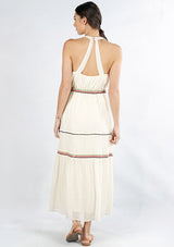 [Color: Natural/Multi] A back facing image of a brunette model wearing an off white sleeveless maxi dress with embroidered accents. 