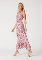 [Color: Dusty Purple/Taupe] A side facing image of a blonde model wearing a pink and purple floral print maxi dress. With ruffled tank top straps, a ruffle trimmed square neckline, an elastic waist, a tiered long skirt, and a lace up top. 