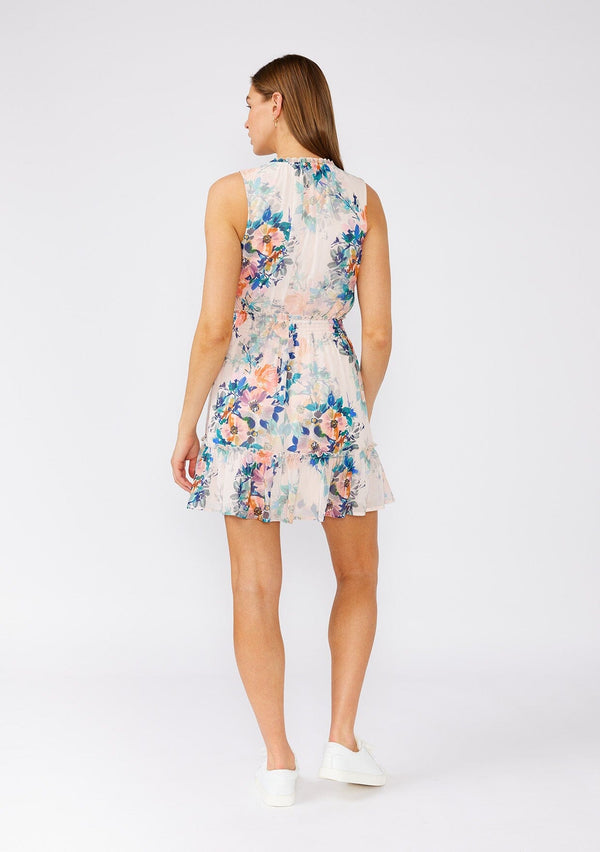 [Color: Peach/Teal] A back facing image of a brunette model wearing a pretty sleeveless mini dress in a pink and teal blue floral print. Designed in chiffon, with a ruffled neckline, a v neck front, a smocked elastic waist, a ruffle trimmed tiered skirt, and a loop button front top. 