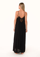 [Color: Black] A back facing image of a blonde model wearing a black summer bohemian maxi tank dress. With adjustable spaghetti straps, a v neckline, a flowy fit, and a soutache braided detail at the back.