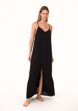 [Color: Black] A front facing image of a blonde model wearing a black summer bohemian maxi tank dress. With adjustable spaghetti straps, a v neckline, a flowy fit, and a soutache braided detail at the back.