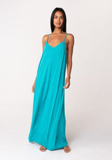 [Color: Turquoise] A front facing image of a brunette model wearing a turquoise blue summer bohemian maxi tank dress. With adjustable spaghetti straps, a v neckline, a flowy fit, and a soutache braided detail at the back. 