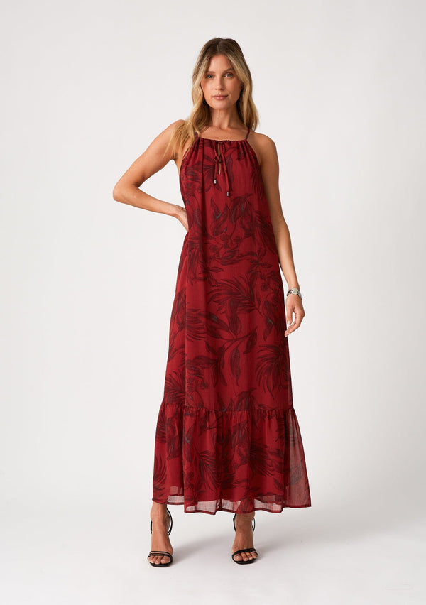 [Color: Wine/Charcoal] A front facing image of a blonde model wearing a dark red chiffon halter maxi dress. With a drawstring halter neckline, a front keyhole, a tiered skirt, and an ultra flowy silhouette.
