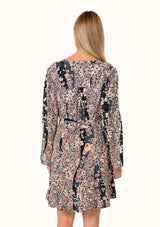 [Color: Dusty Rose/Navy] A back facing image of a blonde model wearing a bohemian fall mini dress in a blue and pink mixed floral print. With long sleeves, a split v neckline, a flowy paneled skirt, a button front, and an adjustable waist tie. 
