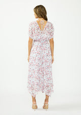 [Color: Grey/Dusty Rose] A back facing image of a brunette model wearing a floral maxi dress with a burnout texture, short dolman sleeves, an asymmetrical hem, and a tie back detail. 