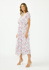 [Color: Grey/Dusty Rose] A side facing image of a brunette model wearing a floral maxi dress with a burnout texture, short dolman sleeves, an asymmetrical hem, and a tie back detail. 