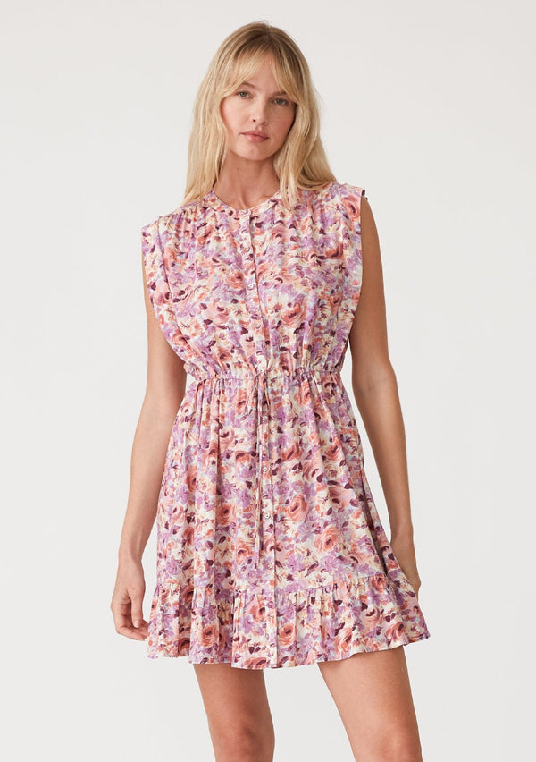 [Color: Dusty Purple/Taupe] A front facing image of a blonde model wearing a pink and purple floral print sleeveless mini dress. With a round neckline, a self covered button front, a tiered mini skirt, and a drawstring waist with ties. 