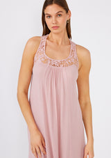 [Color: Dusty Rose] A close up front facing image of a brunette model wearing a flowy sleeveless bohemian maxi dress in dusty pink. With a crochet top, a scooped neckline, and an open back detail. 