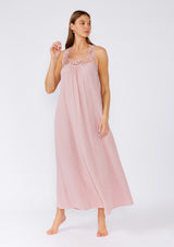[Color: Dusty Rose] A full body front facing image of a brunette model wearing a flowy sleeveless bohemian maxi dress in dusty pink. With a crochet top, a scooped neckline, and an open back detail. 