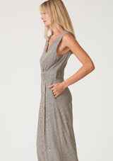 [Color: Taupe/Navy] A close up side facing image of a blonde model wearing a sleeveless jumpsuit in a taupe and navy blue stripe. With a v neckline, side pockets, a wide leg, a concealed back zip closure, and a back keyhole with single button closure. 