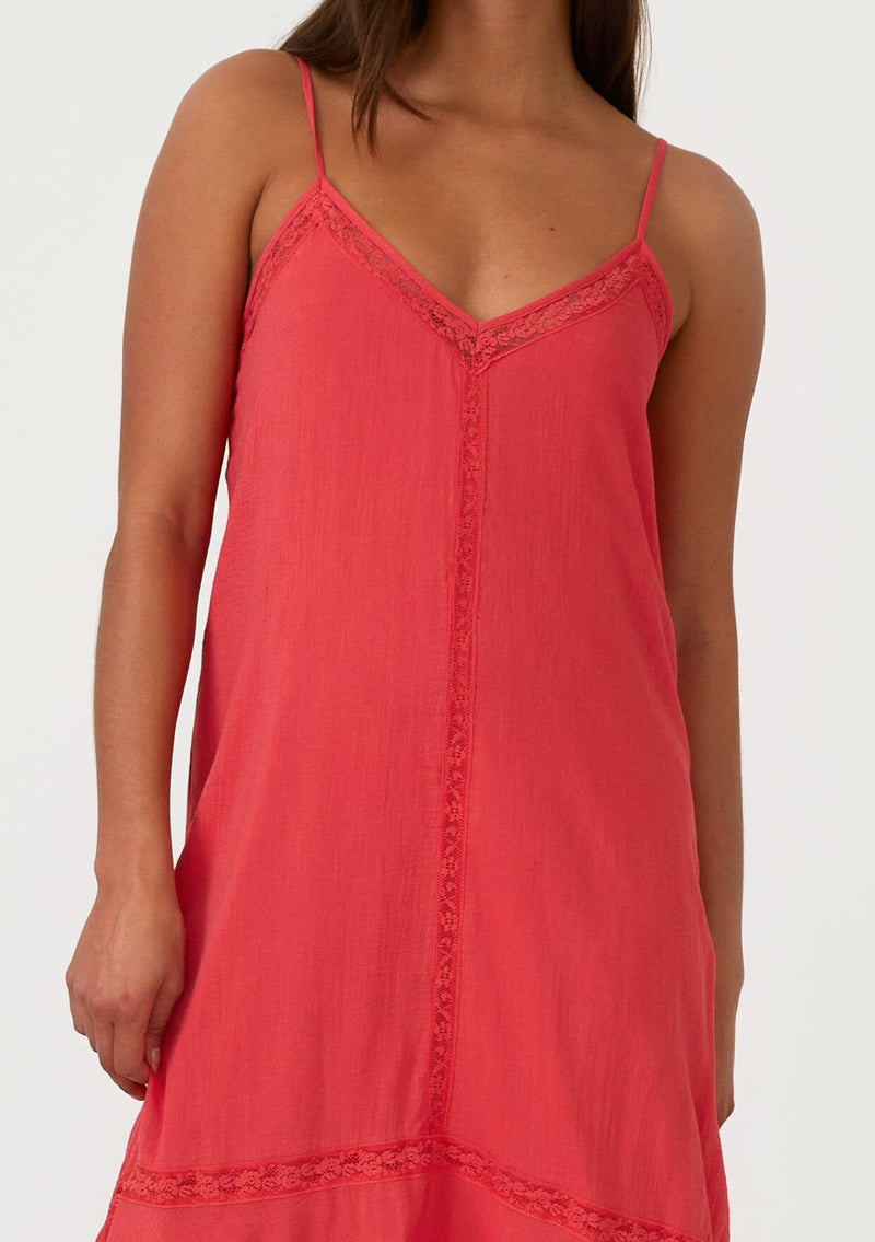 [Color: Hibiscus] A close up front facing image of a bright red bohemian sleeveless maxi dress. With adjustable spaghetti straps, a v neckline, a flowy tiered skirt with a high low hemline, a loop button up back detail, and lace trim. 
