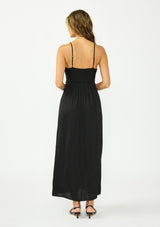 [Color: Black] A back facing image of a brunette model wearing a classic lace trim maxi dress with a v neckline, spaghetti straps, and side slits. 