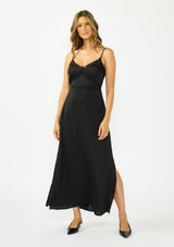[Color: Black] A front facing image of a brunette model wearing a classic lace trim maxi dress with a v neckline, spaghetti straps, and side slits. 