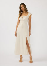 [Color: Natural] A front facing image of a brunette model wearing a beige linen blend maxi dress with short sleeves, a square neckline with tie detail, and a flowy skirt with a side slit. 