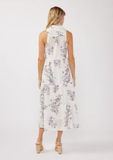 [Color: Off White/Lilac] A back-facing image of a blonde model wearing a sleeveless purple floral midi shirt dress. The dress features embroidered eyelets, a collared neckline, a button-front design, and a tiered skirt. Ideal for weddings, Easter, or other special occasions.